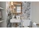 Elegant bathroom featuring a vintage-style sink with brass fixtures and decorative wallpaper at 176 Smith St, Charleston, SC 29403