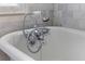 Detailed shot of stylish chrome vintage bathtub faucet with shower wand at 176 Smith St, Charleston, SC 29403