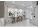Bright and airy dining area with a bar counter and stools overlooking the backyard at 176 Smith St, Charleston, SC 29403