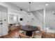 Open-concept dining area featuring hardwood floors, staircase, and views into the cozy living room at 176 Smith St, Charleston, SC 29403