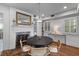 Dining area with wood flooring, a black table, and fireplace with decorative mantle and mirror at 176 Smith St, Charleston, SC 29403