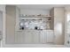 Custom kitchen cabinets and marble backsplash complemented by white painted floors, creating a clean and modern look at 176 Smith St, Charleston, SC 29403