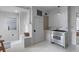 Bright kitchen with stainless steel stove, custom cabinets, and white painted floors, offering a cozy cooking space at 176 Smith St, Charleston, SC 29403