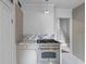 Modern kitchen featuring a stainless steel range, marble countertops, and custom cabinets, perfect for cooking at 176 Smith St, Charleston, SC 29403