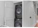 A stacked washer and dryer set in a closet with beadboard walls at 176 Smith St, Charleston, SC 29403