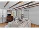 Bright living room with exposed beams, hardwood floors, and comfortable, plush furnishings at 176 Smith St, Charleston, SC 29403