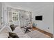 Bright living room with beadboard walls, hardwood flooring, and streaming natural light at 176 Smith St, Charleston, SC 29403