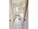 Well-lit bathroom with a white vanity, large mirror, walk-in shower, and a window for natural light at 1804 Bass Rd, Moncks Corner, SC 29461
