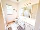 Bright bathroom with a large mirror, white cabinetry, and neutral finishes, offering a serene and clean ambiance at 1804 Bass Rd, Moncks Corner, SC 29461