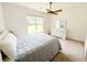 Cozy bedroom with a large window providing backyard views, a ceiling fan, and a stylish white dresser at 1804 Bass Rd, Moncks Corner, SC 29461
