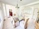 Dining area showcasing tiled floor, chandelier, and access to the adjacent living space at 1804 Bass Rd, Moncks Corner, SC 29461