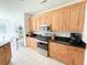 Kitchen featuring wood cabinets, black countertops, and stainless steel appliances at 1804 Bass Rd, Moncks Corner, SC 29461