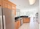 Kitchen featuring stainless steel refrigerator, wood cabinets, granite countertops, and tiled floors at 1804 Bass Rd, Moncks Corner, SC 29461