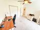 Bright office space features a ceiling fan, neutral carpet, and ample natural light from an adjoining room at 1804 Bass Rd, Moncks Corner, SC 29461