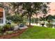 Landscaped backyard features a stone patio with outdoor furniture set near a serene lake at 1809 Two Cedar Way, Mount Pleasant, SC 29466