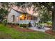 Spacious backyard featuring a screened porch, stone patio with seating, and meticulously landscaped surroundings at 1809 Two Cedar Way, Mount Pleasant, SC 29466