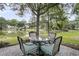 Backyard patio set offers seating with a lake view to create a serene outdoor experience at 1809 Two Cedar Way, Mount Pleasant, SC 29466