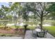Beautiful backyard featuring a stone patio, a table set, and a tranquil view of the nearby lake at 1809 Two Cedar Way, Mount Pleasant, SC 29466