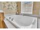 Bathroom featuring a large white soaking tub with chrome fixtures at 1809 Two Cedar Way, Mount Pleasant, SC 29466