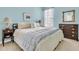 Light blue bedroom with large bed, side tables, and two dressers with serene natural lighting at 1809 Two Cedar Way, Mount Pleasant, SC 29466