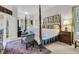 Spacious bedroom featuring a four-poster bed, a sitting chair and neutral color palette at 1809 Two Cedar Way, Mount Pleasant, SC 29466
