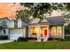 Charming home featuring a welcoming front porch, a bright red front door, and a lush, landscaped yard at 1809 Two Cedar Way, Mount Pleasant, SC 29466