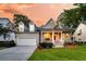 Beautiful home showcasing a lovely porch, manicured lawn, and an attached two-car garage at 1809 Two Cedar Way, Mount Pleasant, SC 29466