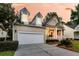 Spacious two-car garage complementing this charming home with a bright red front door and inviting porch at 1809 Two Cedar Way, Mount Pleasant, SC 29466