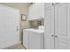 Bright laundry room features white cabinets for ample storage and a practical washer and dryer at 1809 Two Cedar Way, Mount Pleasant, SC 29466