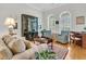 Cozy living room with hardwood floors, large windows, and refined decor and stylish furnishings at 1809 Two Cedar Way, Mount Pleasant, SC 29466