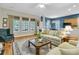 Bright living room with large windows, hardwood flooring, and comfortable seating at 1809 Two Cedar Way, Mount Pleasant, SC 29466