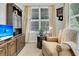 Cozy living room features wood built-ins, a sitting chair, and carpeted floors at 1809 Two Cedar Way, Mount Pleasant, SC 29466