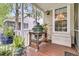 Charming outdoor grill area with a Big Green Egg and lush potted plants on a cozy porch at 1809 Two Cedar Way, Mount Pleasant, SC 29466
