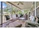 Relaxing screened porch features plush seating, ceiling fan, and serene views of the lake at 1809 Two Cedar Way, Mount Pleasant, SC 29466