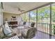 Relaxing screened porch with comfortable seating and serene lake views offers a tranquil escape at 1809 Two Cedar Way, Mount Pleasant, SC 29466