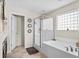 Bright bathroom with glass shower, soaking tub, tile flooring, and abundant light at 1821 Towne St, Johns Island, SC 29455