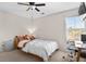 Well-lit bedroom with carpet, ceiling fan, desk, window with blinds, and cozy bed at 1821 Towne St, Johns Island, SC 29455