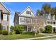Charming two-story home featuring gray siding, black shutters, and a well-maintained front yard at 1821 Towne St, Johns Island, SC 29455