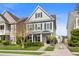 Charming two-story home featuring gray siding, black shutters, and a well-maintained front yard at 1821 Towne St, Johns Island, SC 29455