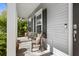 Cozy covered front porch with seating, offering a relaxing outdoor space with natural light at 1821 Towne St, Johns Island, SC 29455