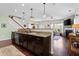 Open-concept kitchen with dark cabinets, granite countertops, and modern appliances, ideal for cooking at 1821 Towne St, Johns Island, SC 29455