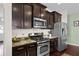 Well-equipped kitchen with stainless steel appliances and dark wood cabinetry at 1821 Towne St, Johns Island, SC 29455