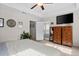 Spacious main bedroom with tray ceiling, TV, adjoining bathroom, and bright natural light at 1821 Towne St, Johns Island, SC 29455