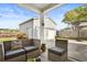 Inviting patio featuring stylish outdoor seating, adjacent to a detached garage with basketball hoop at 1821 Towne St, Johns Island, SC 29455