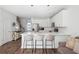 Open-concept kitchen featuring white cabinetry, stainless steel appliances, an island, and hardwood floors at 202 Kirkland St, Goose Creek, SC 29445