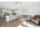 Bright open-concept living room features a kitchen island with bar seating and modern gray furnishings at 202 Kirkland St, Goose Creek, SC 29445