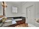 Classic bathroom features marble countertop vanity and jacuzzi tub encased in wood paneling at 208 Sumter Ave, Summerville, SC 29483