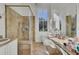 Well-lit bathroom featuring a glass enclosed shower, tile flooring, and built in vanity area at 208 Sumter Ave, Summerville, SC 29483