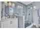Modern bathroom features glass shower, patterned tile, updated vanity with a round mirror, and stylish lighting at 208 Sumter Ave, Summerville, SC 29483