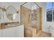 Bright bathroom featuring a glass enclosed shower, tiled walls, and elegant vanity at 208 Sumter Ave, Summerville, SC 29483